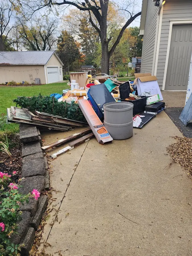 Dumpster being loaded with debris for 12 Yard Dumpster Rental in Dryden